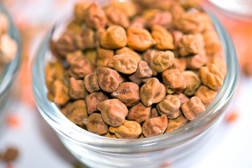 A close-up view of brown or black chickpeas (Kala Chana) in a glass bowl. These legumes are packed with protein, fiber, and essential nutrients, making them a staple in many Indian and Middle Eastern