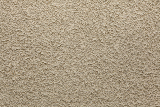 Beige painted stucco wall. Background texture.