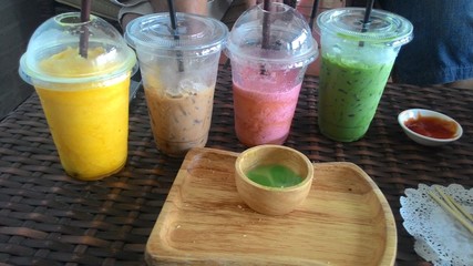 Colorful cold drink in a plastic cup . coffee shop.Fruit smoothies