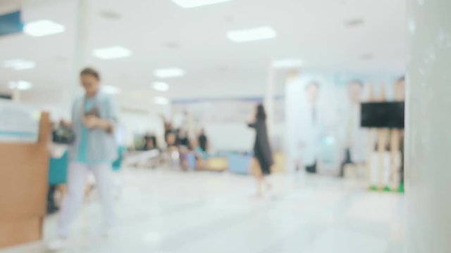 Blurred image with people walking and used wheelchair in hospital
