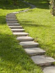 Stone walkway, sidewalk, pathways in the green park.