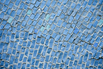 Fototapeta premium Background of blue ceramic mosaic. A wall with a textured surface.