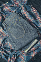 Blue Jeans Pocket and Jeans Legs Denim, 100% Cotton Unsanforized Denim Red Selvage Jeans on Plaid Shirt vintage tone color style background, selective focus (detailed close-up shot) 