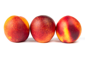 Juicy ripe peaches on the white background in macro