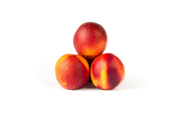 Closeup of fresh peaches in perspective on the white clean background