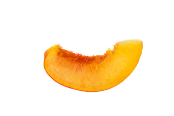 Slice of ripe peach fruit macro on white background