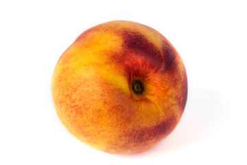 A ripe peach in macro on the white background