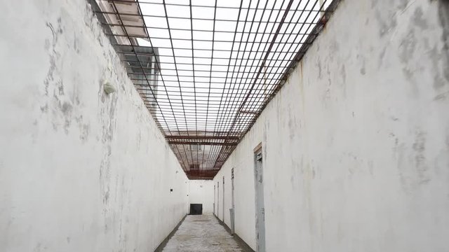 Corridor of a walking yard with doors in the correctional colony, jail in Russia in winter