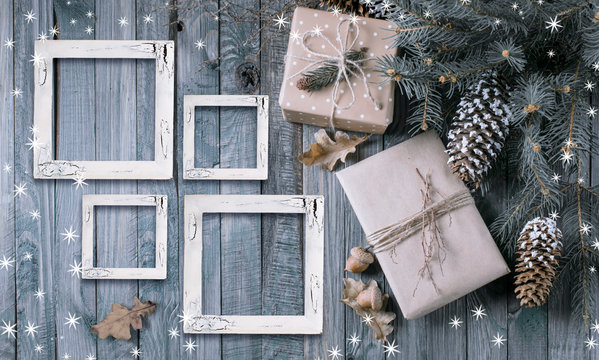 Christmas background with gift box and frames on wooden planks