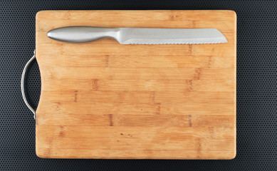 Kitchen cutting board and knife on a table