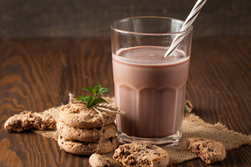 Chocolate, coffee, milk, banana shake on wooden background. Smoothie with cookies. Milkshake. Protein diet. Healthy food concept.