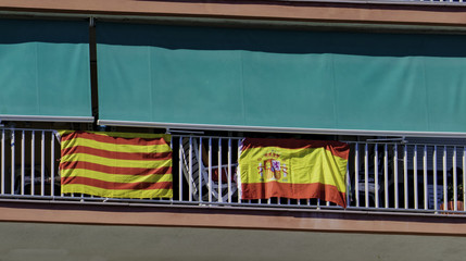 The national flag of Spain and the flag of Catalonia are hung out together on the balcony of the...