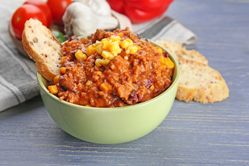 Bowl with chili con carne on table