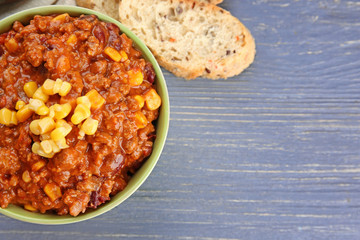 Bowl with chili con carne on table