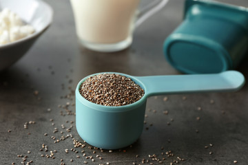 Measuring scoop with chia seeds on table