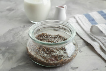 Obraz na płótnie Canvas Glass jar with chia seeds on kitchen table