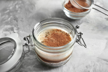 Glass jar with chia seed pudding on kitchen table