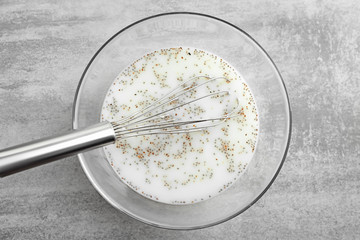 Glass bowl with yogurt and chia seeds on table