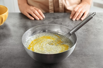 Woman making chia seed pudding in kitchen