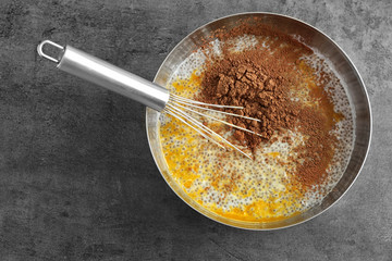 Mix of ingredients for chia seed pudding in bowl on kitchen table