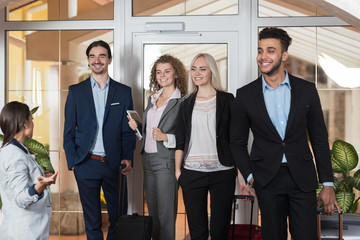 Hotel Administrator Welcome Business People In Lobby, Mix Race Businesspeople Group Guests Arrive...