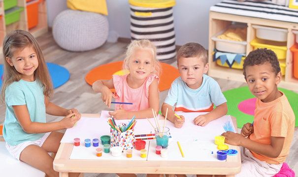 Cute children painting at table indoor