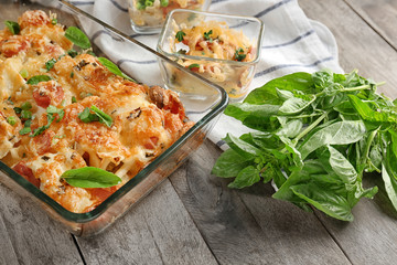 Delicious sausage casserole in baking dish on table