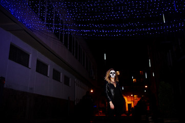 Obraz na płótnie Canvas Halloween skull make up girl wear in black at night street of city.