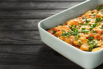 Delicious sausage casserole in baking dish on table, closeup