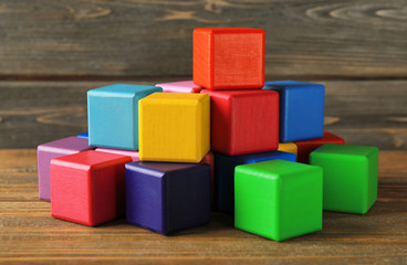 Colorful building blocks on wooden background