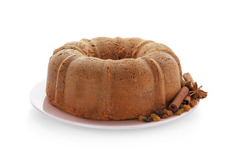 Plate with delicious cinnamon cake on white background