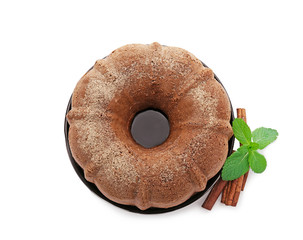 Plate with delicious cinnamon cake on white background