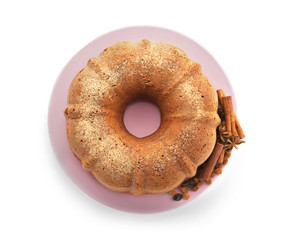 Plate with delicious cinnamon cake on white background