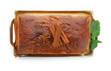 Tray with delicious cinnamon cake on white background