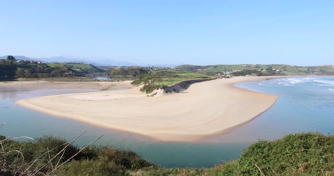 4k video. Panning shot of landscape high view of famous beach named Oyambre and Cantabrian Sea, in San Vicente de la Barquera, Cantabria, Spain, Europe
