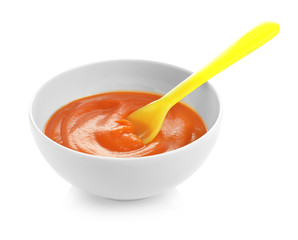 Bowl with baby food on white background