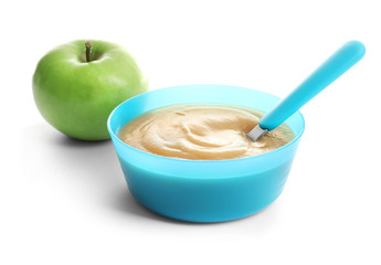 Bowl with baby food on white background
