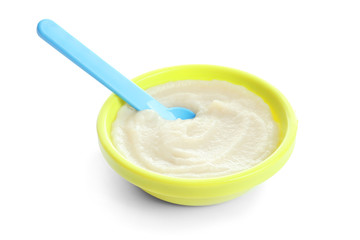 Bowl with baby food on white background