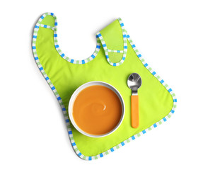 Bowl with baby food on white background