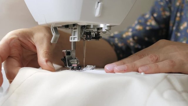 Sewing machine in work close up.