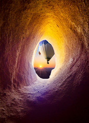 Naklejka premium Hot air balloons at sunrise for your travel concept - view from the cave window in Cappadocia.