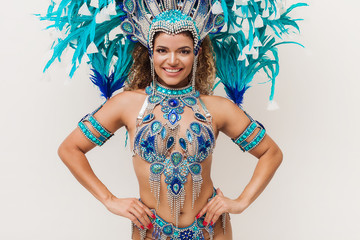 Beautiful samba dancer portrait with arms akimbo while wearing traditional costume