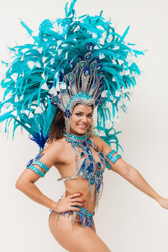 Beautiful brazilian samba dancer smiling and wearing blue traditional costume