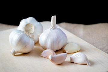 Garlic and Garlic Cloves and bulb on vintage burlap.