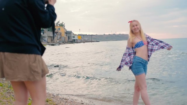 photographer taking photos of a girl on beach