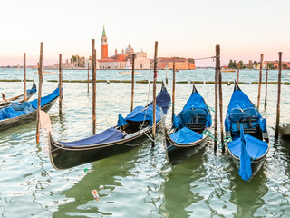 Gondolas moored in the Venetian lagoon