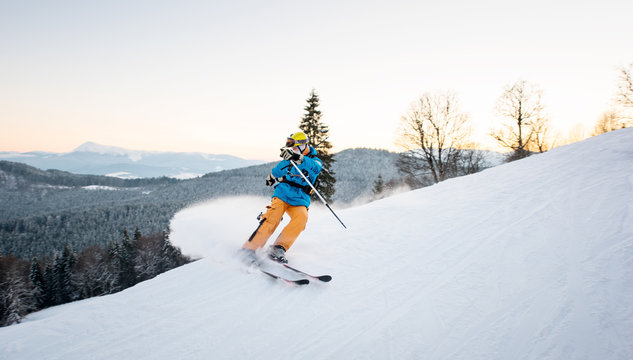 Skier man in snow powder produces braking on the slope of mountain on the winter resort