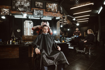 at hairdresser/ Barber cutting in barbershop. Working day at the hairdresser