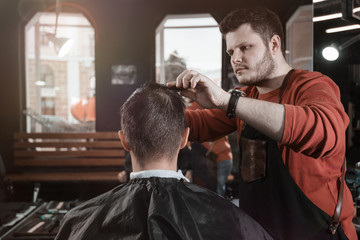 man in hair salon/ Barber cutting in barbershop. View from back of head