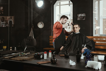Fototapeta na wymiar men hair salon/ Barber shearing client in barbershop. View from Mirror